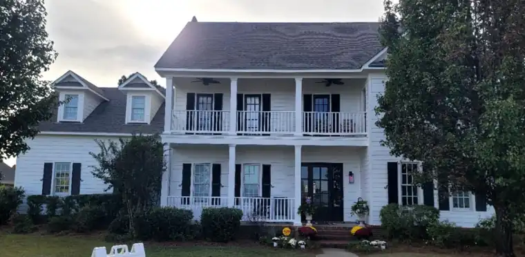 Two-storey house with a double gallery porch, after Anthony's crew repainted it