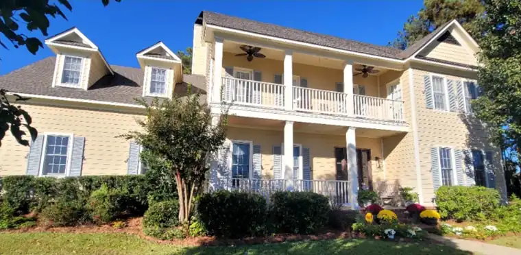 Two-storey house with a double gallery porch, before painting