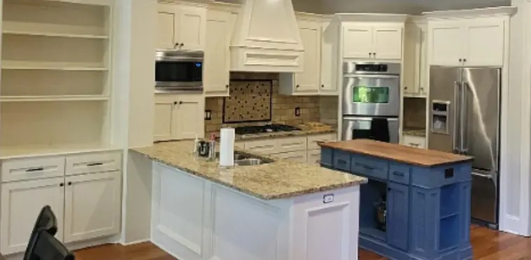 Open kitchen with an island, after Anthony's crew repainted it