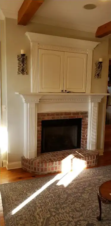 Brick fireplace and wood mantel, before painting