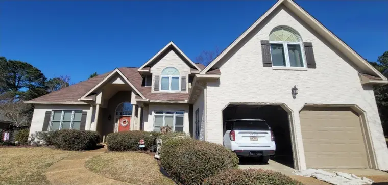 Two-car-garage home after the brick and trim were painted white